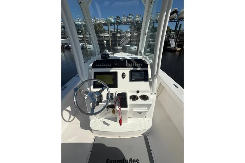 Slide: The Image of 2020 Everglades 243 Center Console boat interior with steering wheel and navigation equipment. - 6