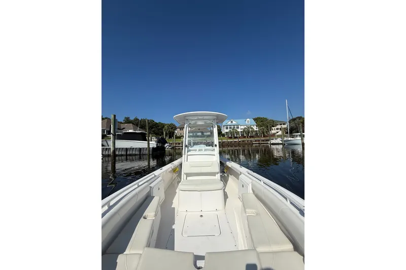 Slide: The Image of 2020 Everglades 243 Center Console boat docked in a scenic marina. - 17