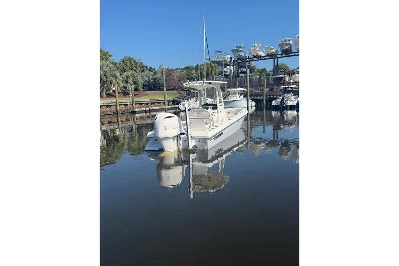 Slide: The Image of 2020 Everglades 243 Center Console boat docked in a marina. - 3