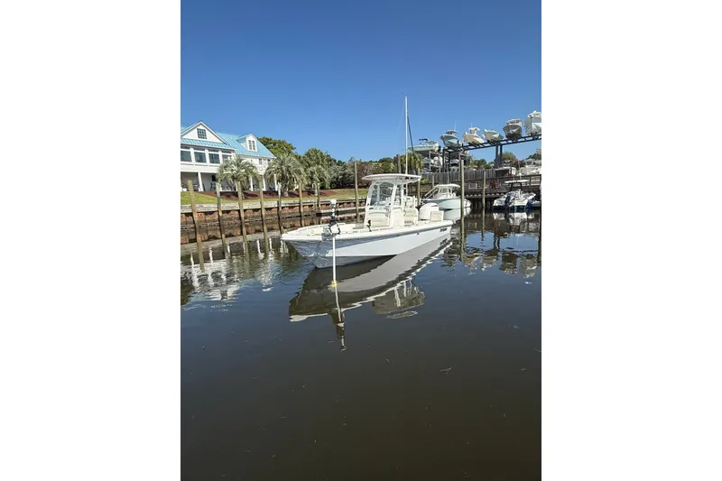 Slide: The Image of 2020 Everglades 243 Center Console boat docked in a serene marina setting. - 14