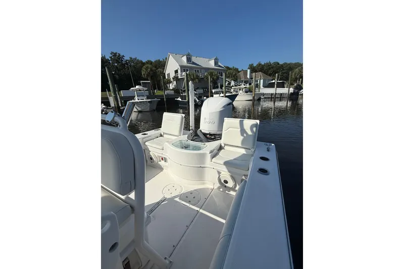 Slide: The Image of 2020 Everglades 243 Center Console boat docked near waterfront homes. - 8