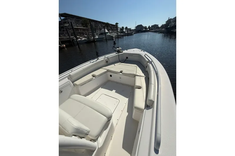Slide: The Image of 2020 Everglades 243 Center Console boat docked in a marina under clear skies. - 4