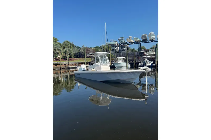 Slide: The Image of 2020 Everglades 243 Center Console boat docked in a serene marina setting. - 18
