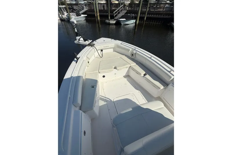Slide: The Image of 2020 Everglades 243 Center Console boat interior with seating and fishing equipment. - 11