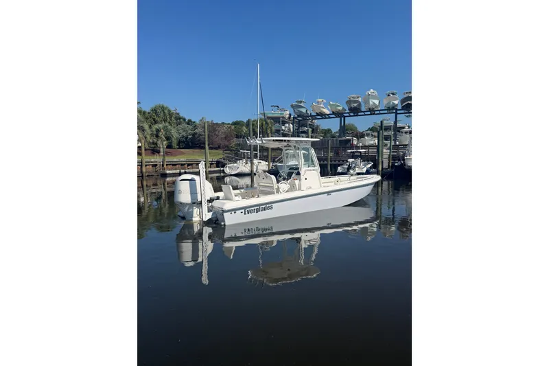 Slide: The Image of 2020 Everglades 243 Center Console boat docked in a marina under clear blue skies. - 13
