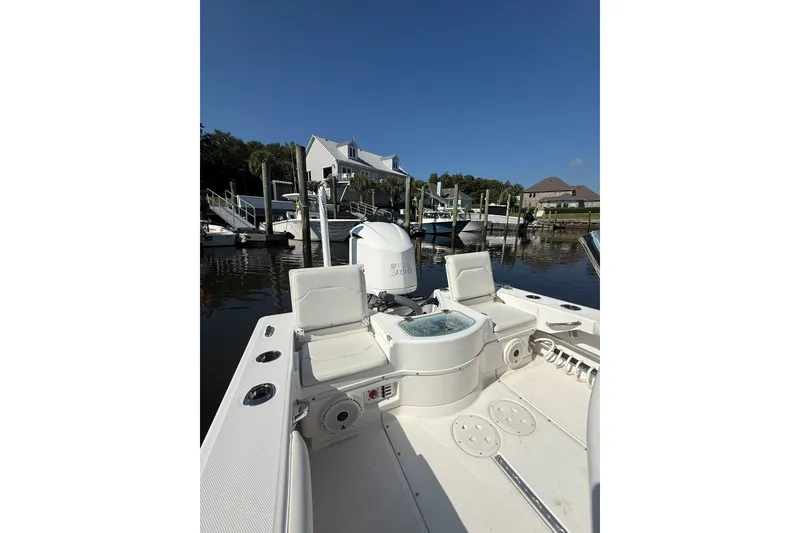 Slide: The Image of 2020 Everglades 243 Center Console boat docked at marina under clear blue sky. - 9