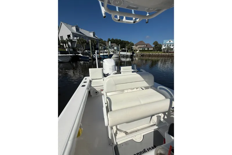 Slide: The Image of 2020 Everglades 243 Center Console boat docked near waterfront homes. - 5