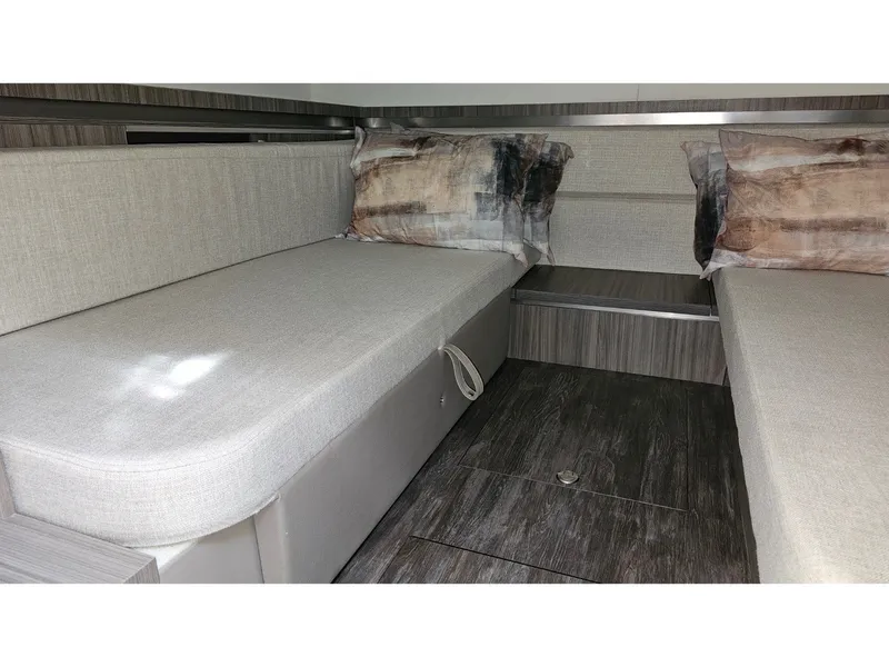 Slide: The Image of Interior of the 2026 Sea Ray Sundancer 320 Coupe Outboard with gray upholstery and wood flooring. - 13