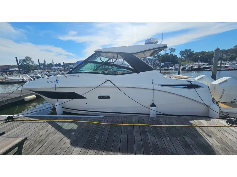 Slide: The Image of 2026 Sea Ray Sundancer 320 Coupe Outboard at dock with sleek design and outboard engines. - 43