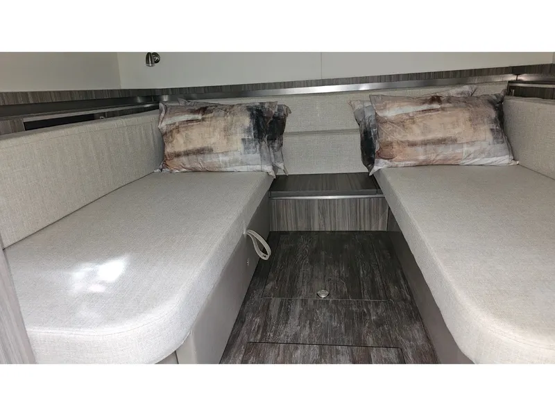 Slide: The Image of Interior of the 2026 Sea Ray Sundancer 320 Coupe Outboard with gray upholstery and wood flooring. - 12