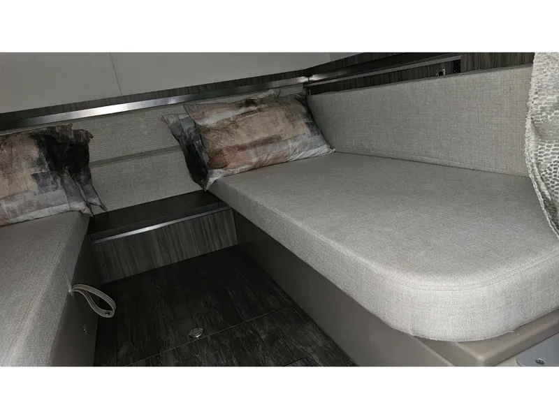 Slide: The Image of Interior of the 2026 Sea Ray Sundancer 320 Coupe Outboard with gray upholstery and cushions. - 14