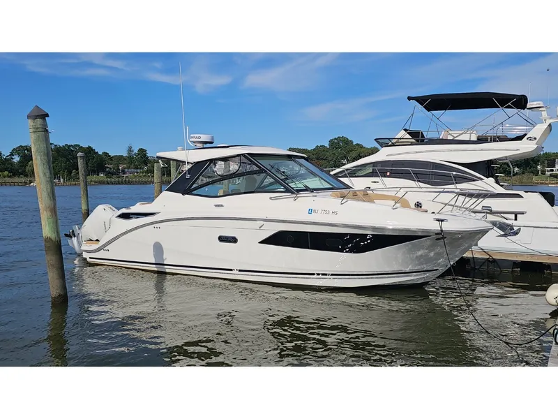 Slide: The Image of Sea Ray Sundancer 320 Coupe Outboard 2026 docked at a pier. - 48