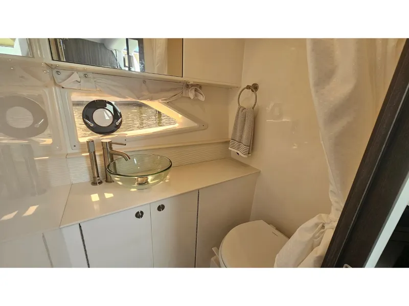 Slide: The Image of Modern bathroom with glass sink and round windows on a yacht. - 10