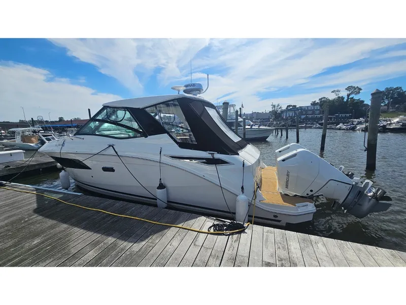 Slide: The Image of 2026 Sea Ray Sundancer 320 Coupe Outboard docked with twin outboard engines. - 5