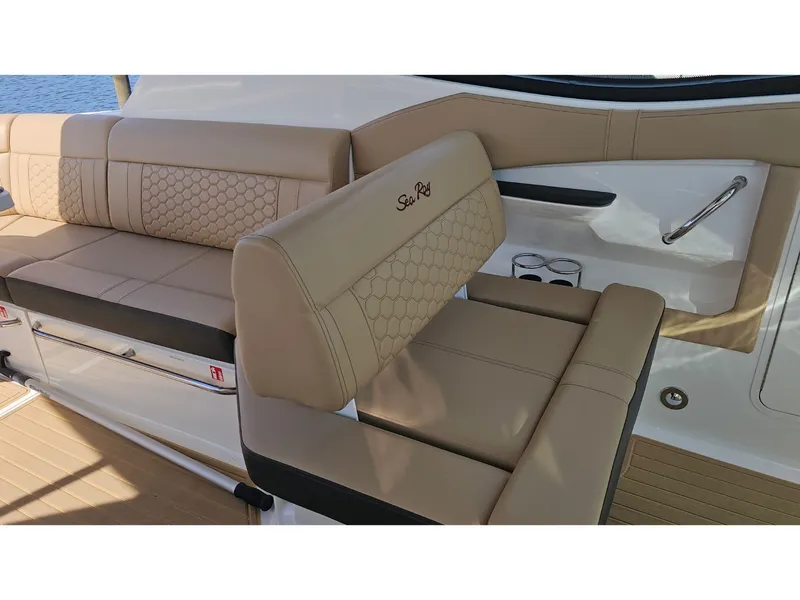 Slide: The Image of The 2026 Sea Ray Sundancer 320 Coupe Outboard features luxurious beige upholstery with a quilted pattern. - 40