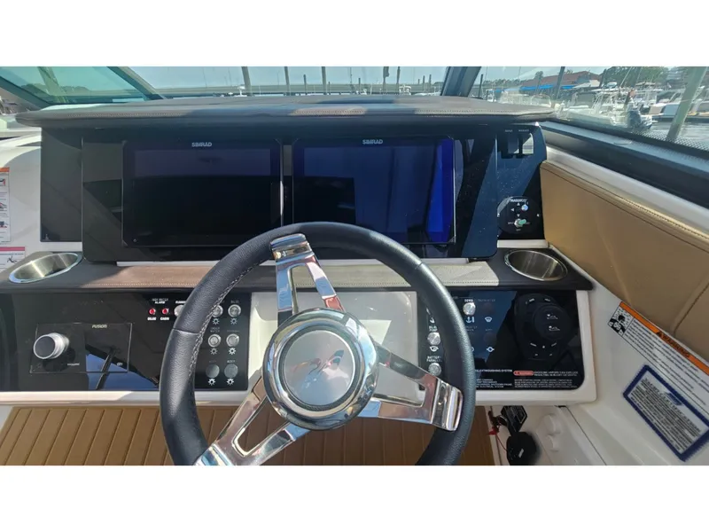 Slide: The Image of The image shows the cockpit of a Sea Ray Sundancer 320 Coupe Outboard with modern instruments. - 35