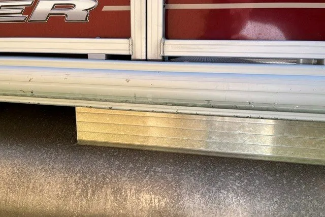 Slide: The Image of 2021 Sun Tracker Bass Buggy 18 DLX pontoon boat detail with red and metallic accents. - 19