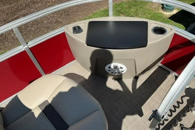 Slide: The Image of 2021 Sun Tracker Bass Buggy 18 DLX interior with beige seating and red paneling. - 14