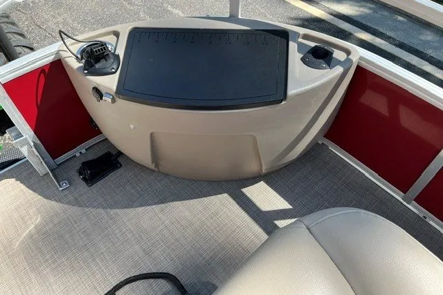 Slide: The Image of 2021 Sun Tracker Bass Buggy 18 DLX boat interior with beige seating and control panel. - 15