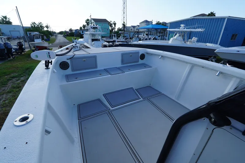 Slide: The Image of 2014 AmeraCat 31 boat interior with spacious deck and seating, docked near other boats. - 8
