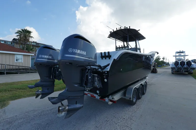 Slide: The Image of 2014 AmeraCat 31 boat with dual Yamaha outboard motors on a trailer. - 4