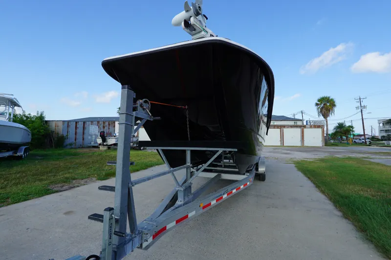Slide: The Image of 2014 AmeraCat 31 boat on trailer, parked outdoors under clear blue sky. - 5