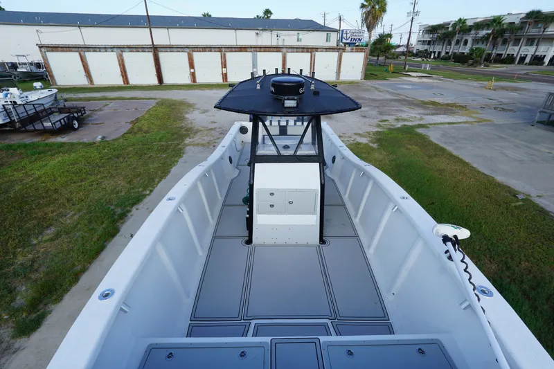 Slide: The Image of 2014 AmeraCat 31 boat with spacious deck and central console, parked outdoors. - 7