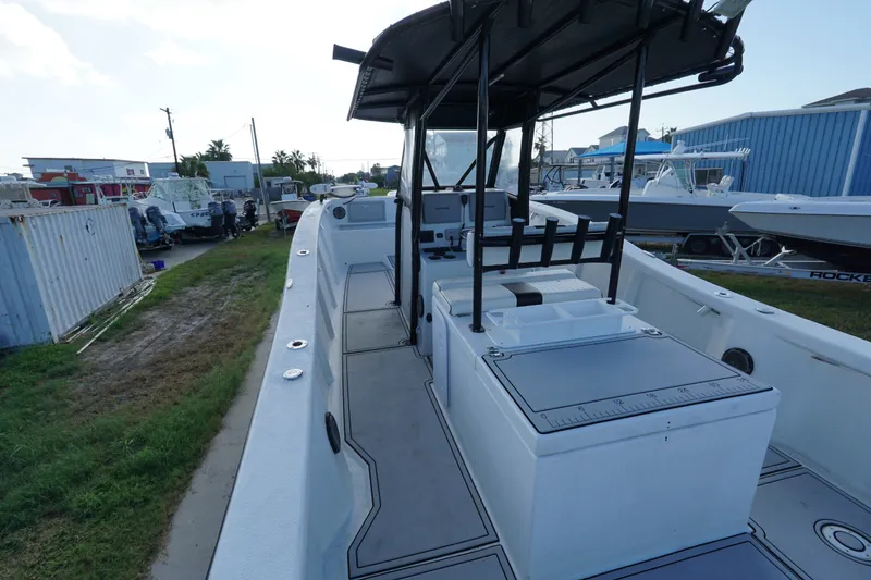 Slide: The Image of 2014 AmeraCat 31 boat interior with seating and storage, docked outdoors. - 12
