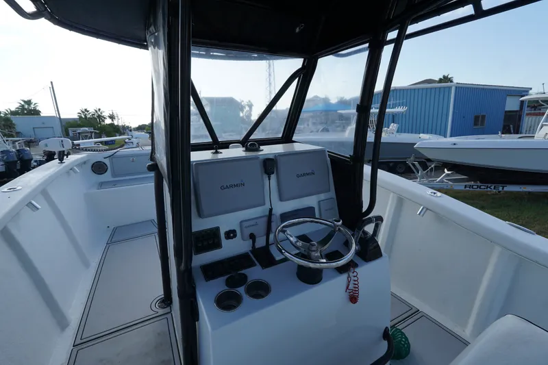Slide: The Image of 2014 AmeraCat 31 boat cockpit with Garmin navigation system and steering wheel. - 10