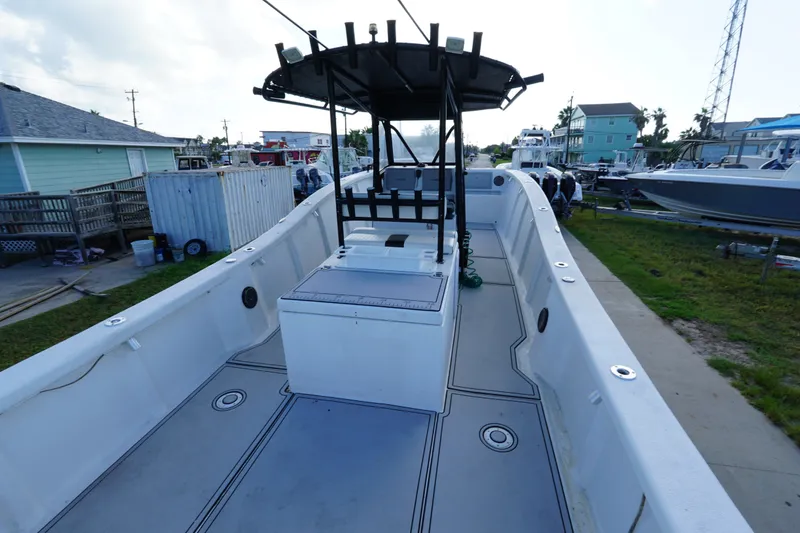 Slide: The Image of 2014 AmeraCat 31 boat with spacious deck and central console, docked in a residential area. - 13