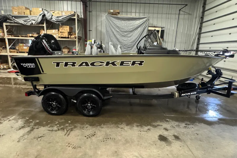 The Image of 2027 Tracker Targa V-18 Combo boat on trailer in a garage setting. - 0