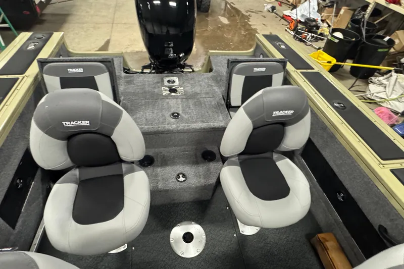Slide: The Image of Interior of 2027 Tracker Targa V-18 Combo boat with gray seating and motor. - 13