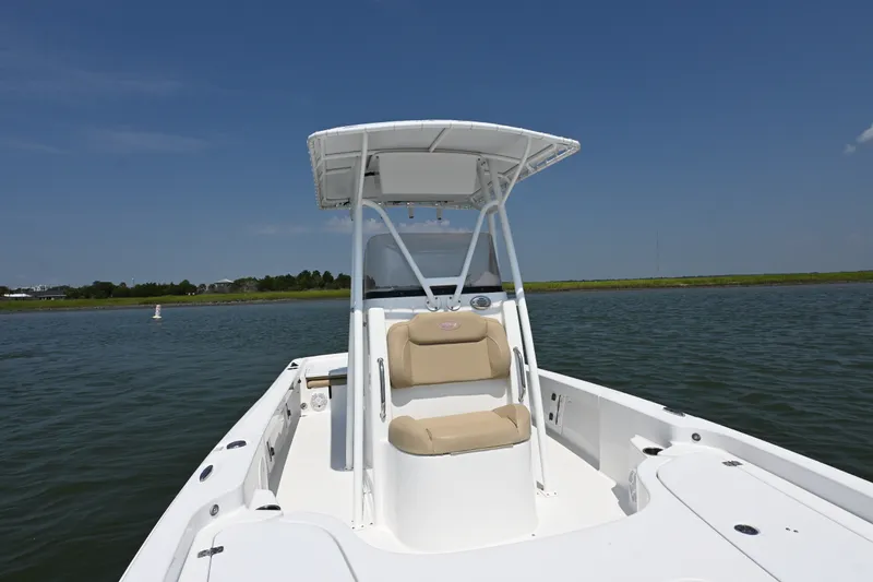 Slide: The Image of 2018 Sea Hunt BX22BR boat on calm water under clear blue sky. - 7