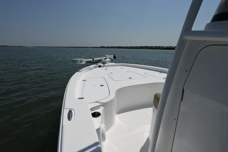 Slide: The Image of 2018 Sea Hunt BX22BR boat on calm water, showcasing sleek deck design. - 6
