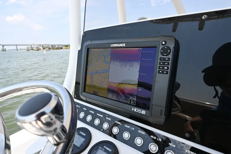 Slide: The Image of Lowrance HDS12 fishfinder on 2018 Sea Hunt BX22BR boat dashboard, near water. - 10