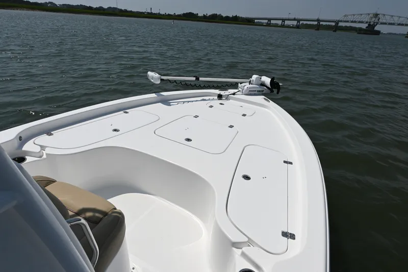 Slide: The Image of 2018 Sea Hunt BX22BR boat on calm water with bridge in background. - 5