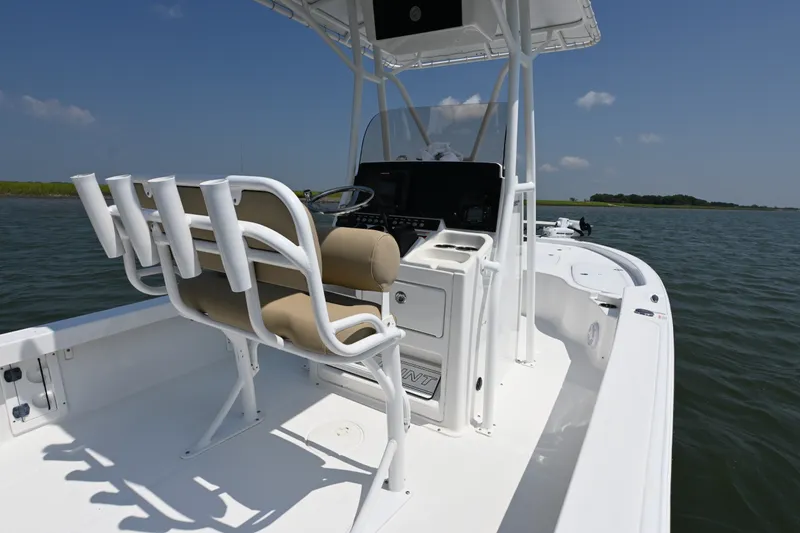 Slide: The Image of 2018 Sea Hunt BX22BR boat interior with helm and seating on calm water. - 12