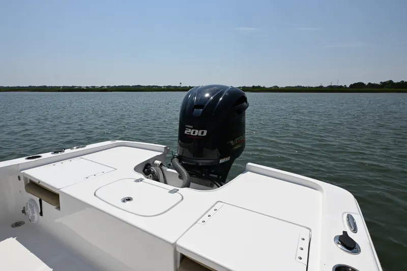 Slide: The Image of 2018 Sea Hunt BX22BR boat with Yamaha 200 engine on calm water. - 14