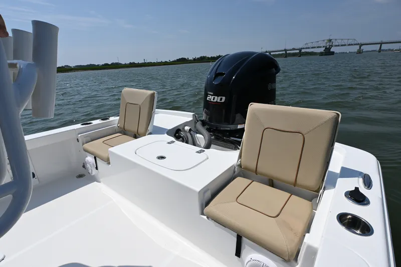 Slide: The Image of 2018 Sea Hunt BX22BR boat with Yamaha 200 engine on calm water. - 13