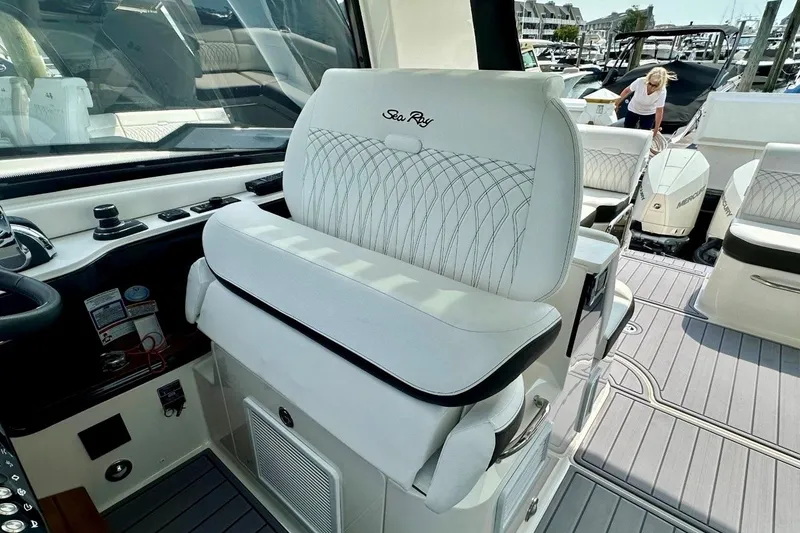 Slide: The Image of 2022 Sea Ray Sundancer 370 Outboard helm seat with elegant white upholstery. - 16