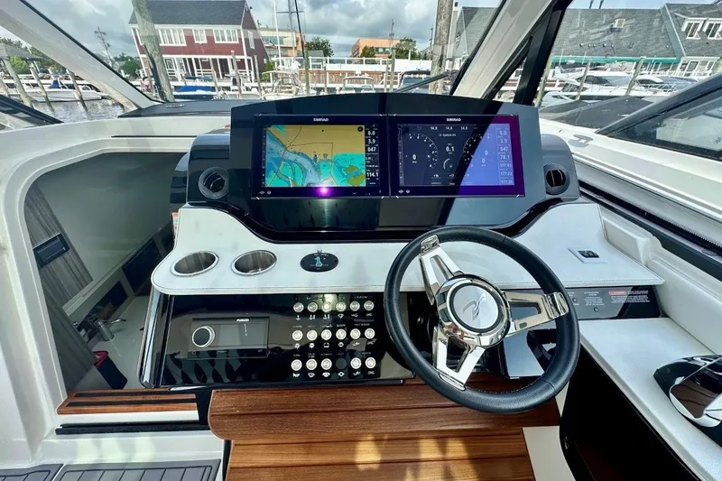 Slide: The Image of 2022 Sea Ray Sundancer 370 Outboard helm with modern navigation display and controls. - 15