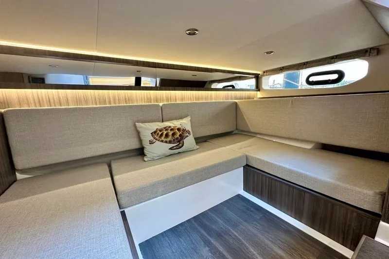 Slide: The Image of Interior of 2022 Sea Ray Sundancer 370 Outboard with cozy seating and turtle pillow. - 21