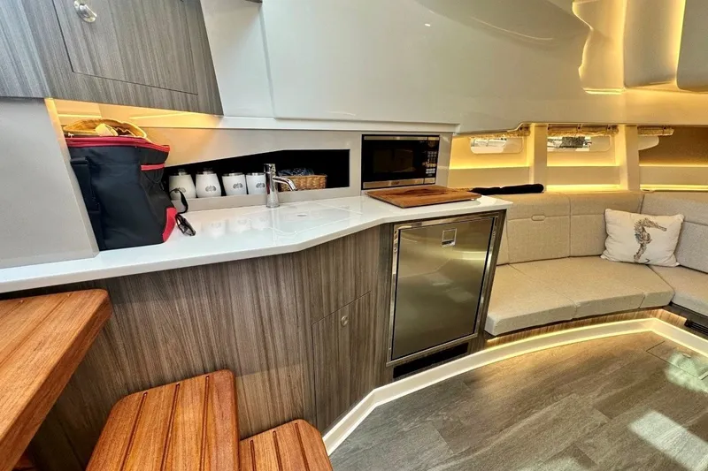 Slide: The Image of Luxurious interior of 2022 Sea Ray Sundancer 370 Outboard with modern kitchenette and seating. - 17