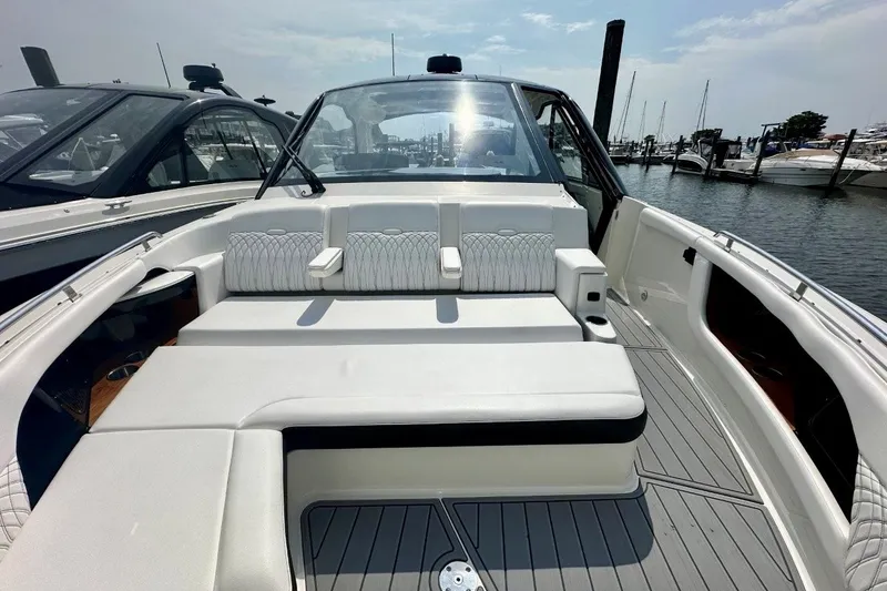Slide: The Image of 2022 Sea Ray Sundancer 370 Outboard boat with spacious seating at a marina. - 6