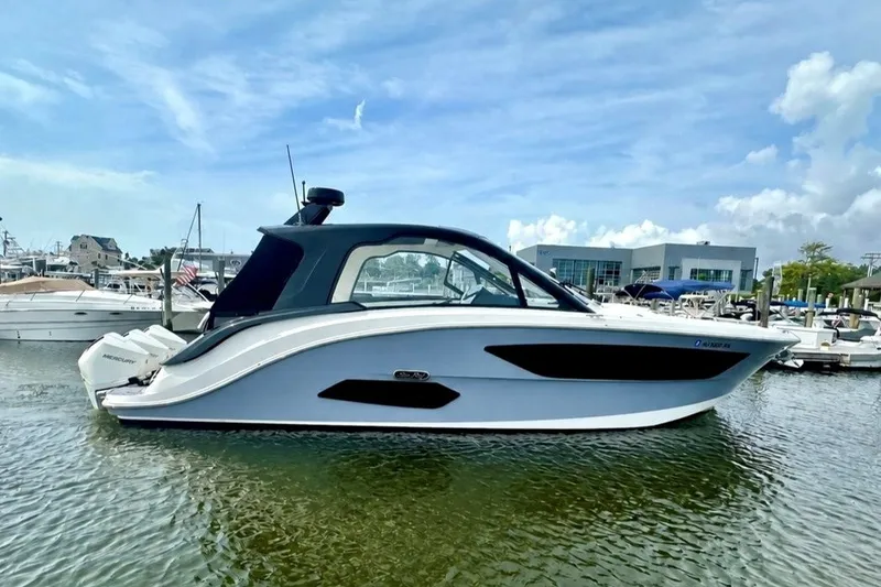 The Image of 2022 Sea Ray Sundancer 370 Outboard yacht docked in marina under blue sky. - 0