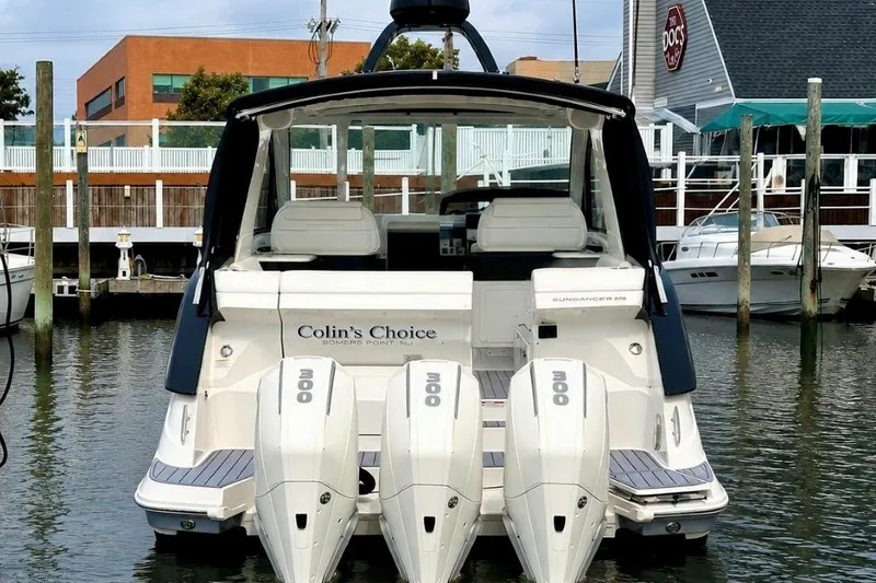 Slide: The Image of 2022 Sea Ray Sundancer 370 Outboard docked, featuring triple 300 horsepower engines. - 1