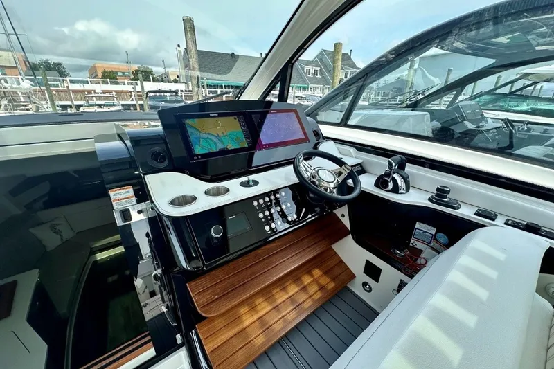 Slide: The Image of 2022 Sea Ray Sundancer 370 Outboard helm with modern navigation displays and controls. - 14