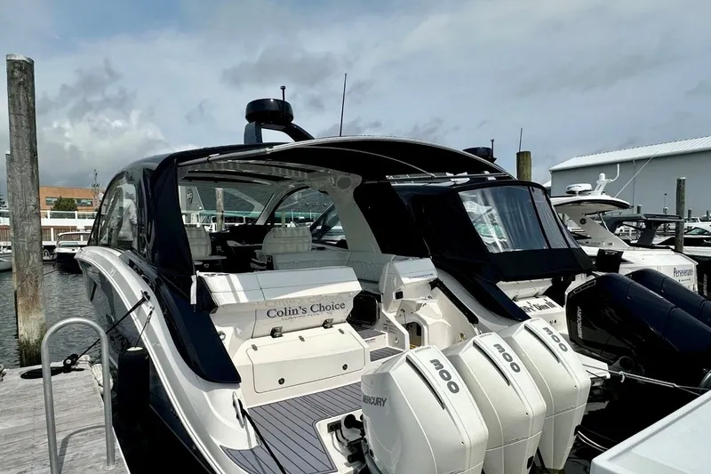 Slide: The Image of 2022 Sea Ray Sundancer 370 Outboard docked, featuring triple Mercury engines. - 3