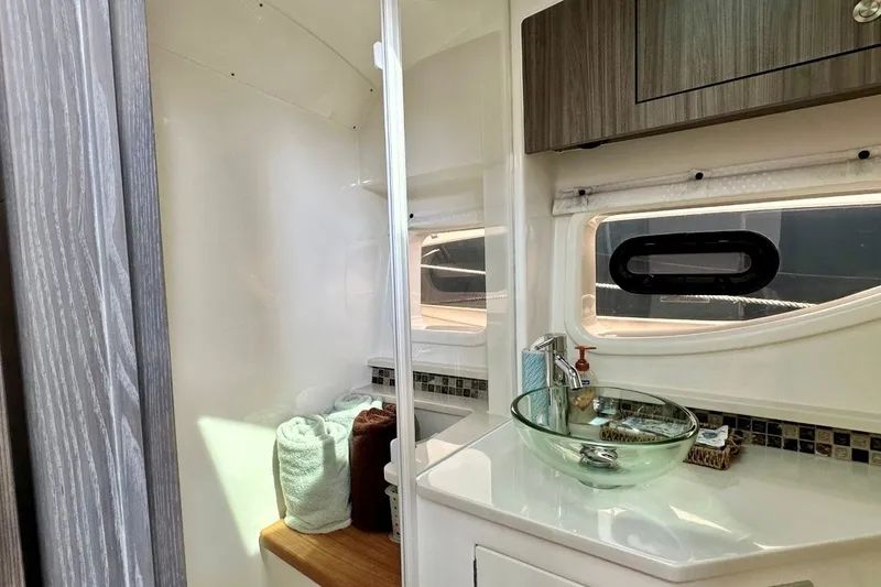 Slide: The Image of Luxurious bathroom interior of 2022 Sea Ray Sundancer 370 Outboard with glass sink and modern fixtures. - 23