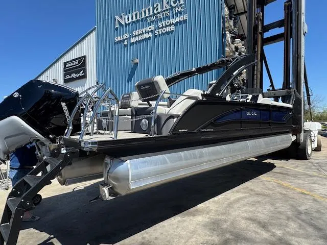 Slide: The Image of 2025 Barletta CORSA 25MA pontoon boat at marina storage facility. - 6